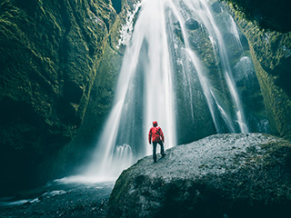 Person in front of waterfall